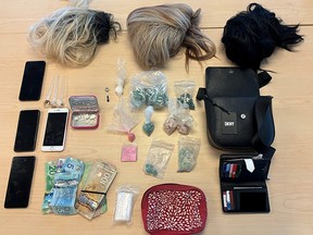 Fentanyl, crack cocaine, crystal methamphetamine and personal items including wigs and multiple cell phones seized by Kingston Police in Kingston, Ont., on Friday, April 19, 2024.