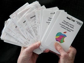 Joan Smith (not her real name), 81, holds the dozens of Apple gift cards she bought, totalling $17,500. A man pretending to be an RCMP investigation convinced the local senior to buy the gift cards and bitcoin as part of his 'investigation.'