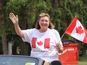 Sarnia-Lambton MP Marilyn Gladu waves while riding in the 2023 Sarnia Canada Day Parade.