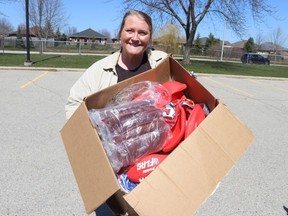 Kate Brandon, who runs Bluewater Flag Football, holds a box of youth league jerseys and footballs that were stolen from her front porch after being delivered Saturday and then recovered and returned Monday by Sarnia police.