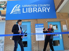 Sarnia Mayor Mike Bradley, right, snaps a photo of Lambton County Warden Kevin Marriott before Tuesday's ribbon-cutting marking the official opening of a county library branch at Sarnia's Clearwater Arena.