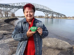 Wendy Marsden holds the head of Rocky the rock snake, a community project the Sarnia retreat began in June on the St. Clair River waterfront.