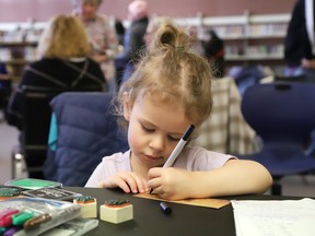 Eloise Chartrand, 3, takes part In an activity at Earth Day celebrations at the main branch of the Greater Sudbury Public Library in Sudbury, Ont. on Monday April 22, 2024.