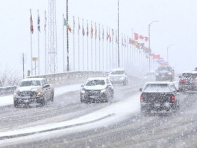 Motorists drive over the Bridge of Nations as snow falls in Sudbury, Ont. on Wednesday April 3, 2024. John Lappa/Sudbury Star/Postmedia Network