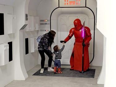 Two-year-old Tsiorahi Sawinson gets a high five from a Star Wars 501st Canadian Garrison Red Guard during the 2024 Northern Ontario Expo at the McIntyre Arena on Saturday. Sawinson and 11-year-old Atlas Polson are both from Timiskaming First Nation. THOMAS PERRY/THE DAILY PRESS