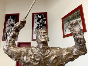 The bronze-resin statue of Father Les Costello appears to be glancing at the heavens in celebration of a life well lived. A replacement for the one damaged beyond repair in March 2023, the new statue was unveiled during a ceremony in the auditorium of the McIntyre Community Complex on Wednesday. It will take its rightful place in the arena entrance, with a few extra measures to ensure its safet. THOMAS PERRY/THE DAILY PRESS