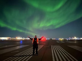 Jack Walsh, an employee at the Fort McMurray International Airport from Waterford, Ireland, sees his first northern lights spectacle on the airport's runway. Photo by Mark Jones and courtesy Fort McMurray Airport Authority