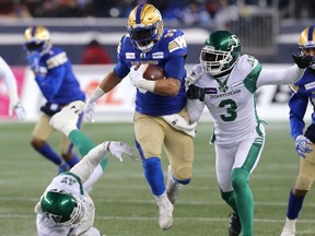 Winnipeg Blue Bombers RB Andrew Harris carries the ball against the Saskatchewan Roughriders in the CFL West Final in Winnipeg on Sun., Dec. 5, 2021.