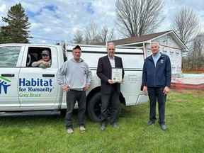 From left, electrical apprentice Colin Hokea, master electrician Mike Frail, Bruce-Grey-Owen Sound MPP Rick Byers and Habitat for Humanity Grey Bruce Executive Director Greg Fryer, with a vehicle that was purchased for the local organization's critical repair program with a grant from the Ontario Trillium Foundation. The program completes repairs to homes at the local Saugeen Ojibway Nation communities.