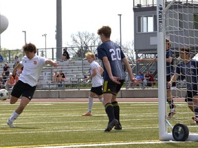North Park Collegiate’s Aidan Turcotte scores for the Trojans in an AABHN boys soccer game against the Assumption College Lions on Monday at Bisons Alumni North Park Sports Complex. Brian Smiley