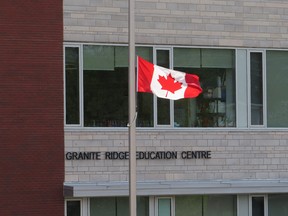 The flag at Granite Ridge Education Centre flies at half-mast in Sharbot Lake, Ont., on Friday, May 10, 2024, following a devastating crash that involved six of its students the day before. (Elliot Ferguson/ The Whig-Standard/ Postmedia Network)