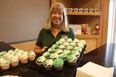 Barbara Prescott, a member of Petrolia's 150th anniversary committee, holds a tray of anniversary cupcakes being served Saturday at a celebration for a new bandshell being built in the town's Victoria Park.