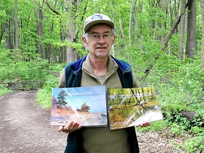 Retired ecologist Allen Woodliffe shows off his two books, Life on a Sandspit and Natural Treasures of Chatham-Kent, that aim to inspire people to get out and explore the natural beauty across Chatham-Kent.  He is seen here at O'Neill Nature Preserve in north Chatham.  (Ellwood Shreve/Chatham Daily News)