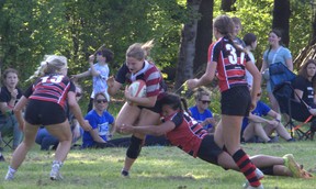Jayden Rogers of Assumption College breaks a Paris District High School tackle on her way to scoring the eventual game-winning try in the AABHN girls rugby semifinals on Monday at the Harlequins Grounds. Brian Smiley