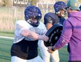 Sudbury Junior Spartans U18 offensive lineman Owen Willis, left, takes part in a drill with head coach Alex Vendramin at James Jerome Sports Complex in Sudbury, Ontario on Wednesday, May 15, 2024.