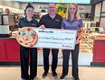 Tim Hortons franchisees Jessica Pritchard and Paul Grail flank foundation chief Mike Genge after this year's local Tim Hortons Smile Cookie campaign raised $55,000 for the Children’s Treatment Centre Foundation of Chatham-Kent recently. (Supplied)