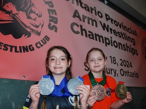 Gwyneth, front, and Scarlett Tessier took on one other and Ontario at the recent provincial arm wrestling championships.