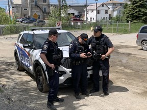 Greater Sudbury Police Service officers operate a drone during an evidentiary search near the scene of a shooting on Agnes Street in Sudbury on Friday. Two people were in custody after an overnight shooting left one person with non-life-threatening injuries, the police service said in a media release.