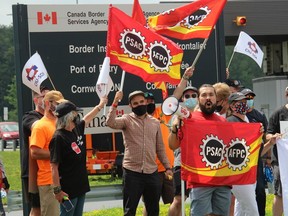 Border services officers and union officials during a mid-day demonstration in Cornwall on Wednesday, July 28, 2021.