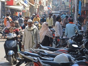 In this picture taken on March 14, 2024, people make their way through a busy market area near the Jama Masjid (mosque) at Rampur in India's Uttar Pradesh state. More than half the voters in India's city of Rampur are Muslim, but its member of parliament is a staunch supporter of Prime Minister Narendra Modi's muscular Hindu-first agenda. While India's 220 million Muslims make up 14 percent of the 1.4 billion population, Muslim representatives in parliament have almost halved to under five percent since the 1970s.