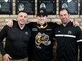 Sarnia Sting first-round draft pick Alessandro Di Iorio is welcomed by general manager Dylan Seca, left, and director of hockey operations David Legwand, right, at a news conference at Progressive Auto Sales Arena in Sarnia, Ont., on Saturday, April 13, 2024. (Mark MalonePostmedia Network)
