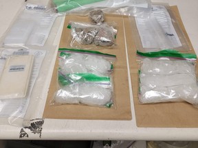 Three people have been charged after police seized drugs valued at about $200,000, weapons and cash in Elliot Lake.