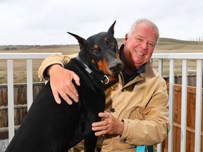 Craig Campbell with his hero dog Night who saved him from a charging momma grizzly during a walk in Cochrane on Tuesday, May 7, 2024.