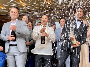 The Stratford Festival opened its 2024 season with a red-carpet gala that included the traditional champagne shower. From left: Eric Abel, Jason Sermonia and Devon Michael Brown take part. Photo taken on May 27, 2024. (Cory Smith/Stratford Beacon Herald)