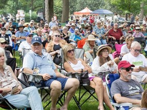 People listen to musicians perform at the Home County Music and Art Festival at Victoria Park in London on Sunday, July 16, 2023. (Derek Ruttan/The London Free Press)