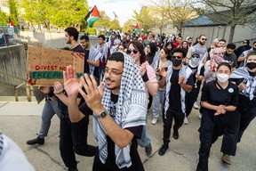 Pro-Palestinian protestors march through Western University in London chanting, “All Zionists are racist. All Zionists are the terrorists,” on Wednesday, May 1, 2024. (Derek Ruttan/London Free Press)