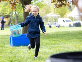 Ellie Bartsch, 7, of McGregor elementary school in Aylmer races with a basket full of balls representing water at the St. Thomas-Elgin Children’s Water Festival on May 9, 2024. (Derek Ruttan/The London Free Press)