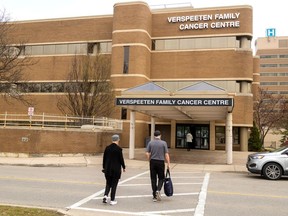People walk toward the Verspeeten Family Cancer Centre at London Health Sciences Centre in London on Monday, April 29, 2024. LHSC held a ceremony Monday to mark the renaming of the former London Regional Cancer Program. (Mike Hensen/The London Free Press)