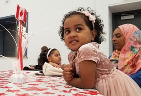 Maisara Albakry, 3, along with her sister, Muna Albakry, 4, and mother, Widaad Al-Busaidy, waits for her father Abdulhakeem Albakny, to recieve a citizenship certificate Wednesday, May 15, 2024 in Owen Sound, Ont. (Scott Dunn/The Sun Times/Postmedia Network)