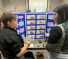 Paige Trofimenkoff talks with judge during the Peace Country Regional Science Fair held in March at the Catholic Conference Centre in Peace River.