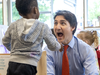 Prime Minister Justin Trudeau shares a light moment with three-year-old Micha Owaseye during a visit to a child-care centre in St. Thomas on Monday, May 13, 2024. (Derek Ruttan/The London Free Press)