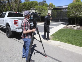 A security guard blocks a TV cameraman from shooting the front gate of Drake's mansion on Tuesday, May 7, 2024, in Toronto.