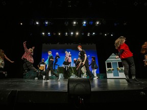 a group of young people dance on a stage