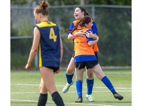 Farah Zebian and Sydnee Sevenyhazi of École secondaire Gabriel-Dumont celebrate a goal as Montcalm’s Ariella Robinson walks past during their TVRA girls high school soccer game in London on Wednesday May 15, 2024. (Derek Ruttan/The London Free Press)