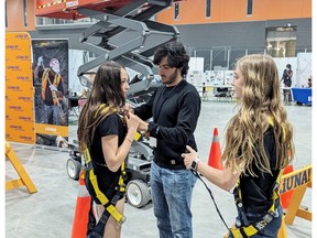 Students put on safety equipment before using the scissor lift at LiUNA Local 837 booth at the Epic Jobs 2024 event held in Brantford on Wednesday.  SUBMITTED