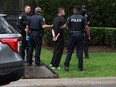 Toronto Police officers are pictured as they arrest a man – described as a “person in crisis” – under the Mental Health Act at Drake’s Bridle Path mansion on May 8, 2024. (Jack Boland, Toronto Sun)