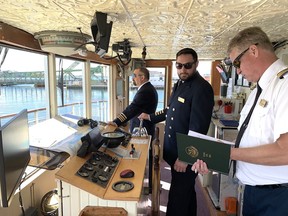 Capt. Tristan McCoubrey, centre, steers the Canadian Empress alongside the Bascule bridge on the LaSalle Causeway in Kingston, Ont. on Thursday, May 9, 2024. Elliot (Ferguson/The Whig-Standard/Postmedia Network)