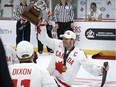 Team Canada captain Tyler McGregor (8) of Forest, Ont., holds the trophy after defeating Team USA to win the world para hockey championship in Calgary on Sunday, May 12, 2024. (Jeff McIntosh/The Canadian Press)