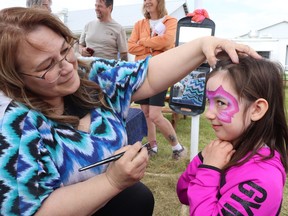 Face painter Deanne Jackson, left, added a splash of colour to Fairthorpe, with Mayerthorpe resident Athena Beverly, five, among those who benefited.