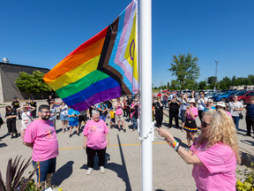 Tami Murray of the group Oxford Pride raises a rainbow Pride flag, a common symbol of LGBTQ support, on a public flag pole in Norwich on May 31, 2024. Mike Hensen/The London Free Press