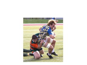 North Park Collegiate’s George Draghiciu takes down Brantford Collegiate Institute’s Ryan Henderson during an AABHN senior boys rugby game at Bisons Alumni North Park Sports Complex on Tuesday. Brian Smiley