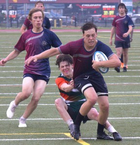 Lynx Bowman of Assumption College breaks a tackle on his way to scoring a try against North Park Collegiate on Tuesday in AABHN senior boys rugby action at Bisons Alumni North Park Sports Complex. Brian Smiley