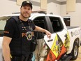 Const. Tyler Callander. Sarnia police's Aamjiwnaang community officer, shows off the new livery of his police vehicle unveiled Tuesday at the First Nation's Maawn Doosh Gumig community centre. (Tyler Kula/ The Observer)