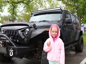 Five-year-old Kcie Walker of Waterford, standing in front of her dad's 2017 Willys Jeep, spent some time on Saturday at the Jeep Invasion at Powell Park in Port Dover.