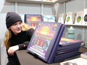 Nolan Harris, 12, of Ecole St-Pierre, takes a close look at a book at Salon du livre du Grand Sudbury at Place des Arts in Sudbury, Ont. on Thursday May 9, 2024.