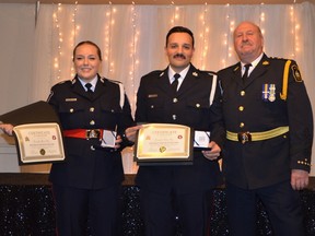 Sault Ste. Marie Police Chief Chief Hugh Stevenson (right) honours Constables Jamie Peace (left) and Chris Perri during a ceremony this week. Supplied photo